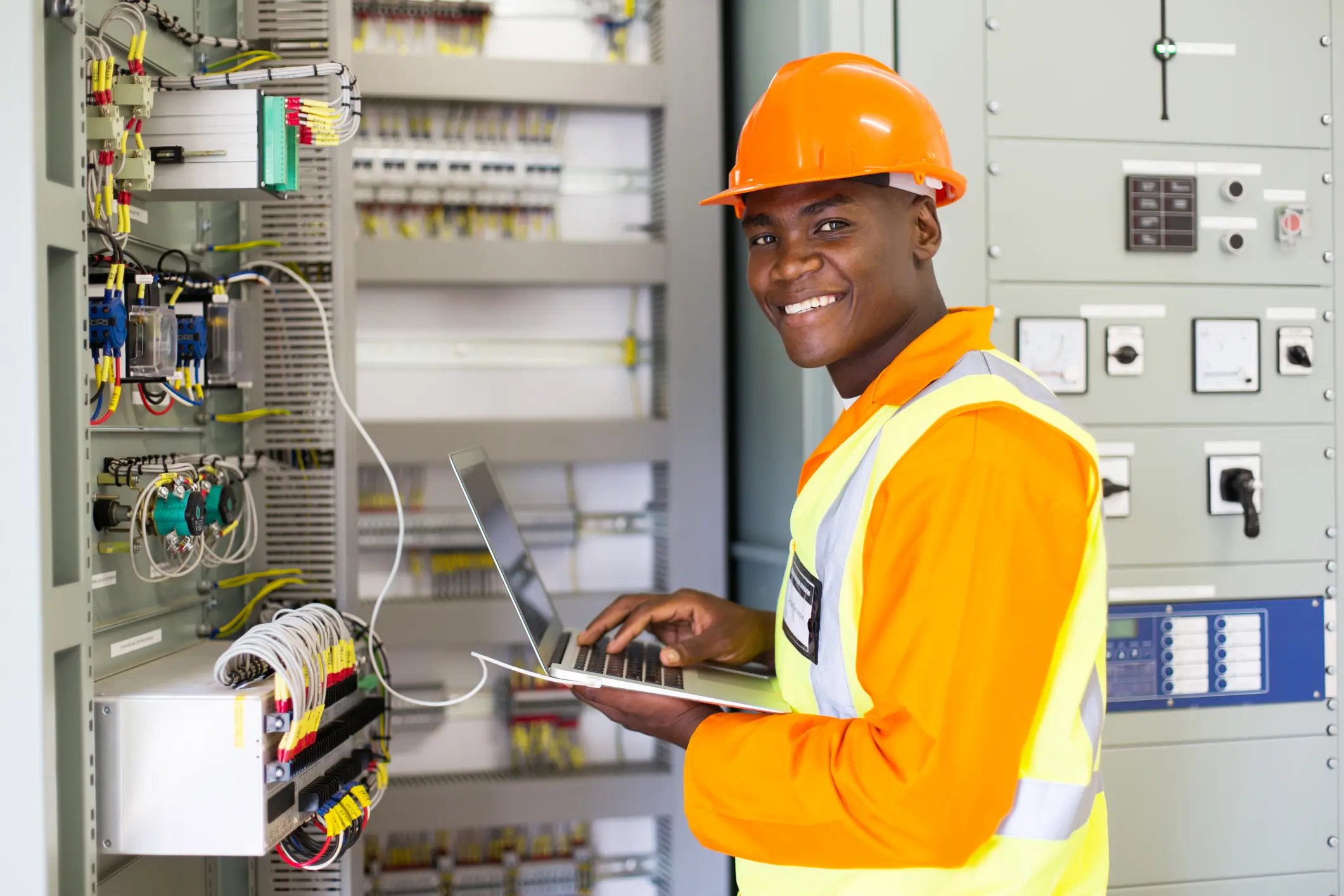 Electrician inspecting and documenting switchgear installation